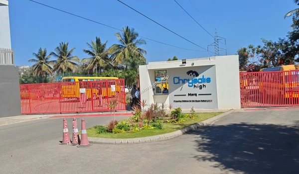 The main access point and security cabin at Chrysalis High Marq, emphasizing the safe and secure educational environment near the Sobha Hoskote development