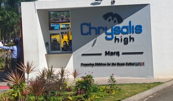 The student drop-off area and campus entrance at Chrysalis High school, highlighting the organized facility management near the Sobha Hoskote project site
