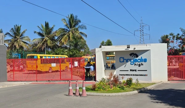 A clear view of the main access gates and school bus bay at Chrysalis High Marq, highlighting social infrastructure accessible from Sobha Hoskote