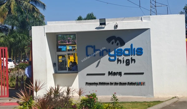 Exterior view of Chrysalis High school entrance near Marq, highlighting the educational infrastructure accessible from Sobha Hoskote