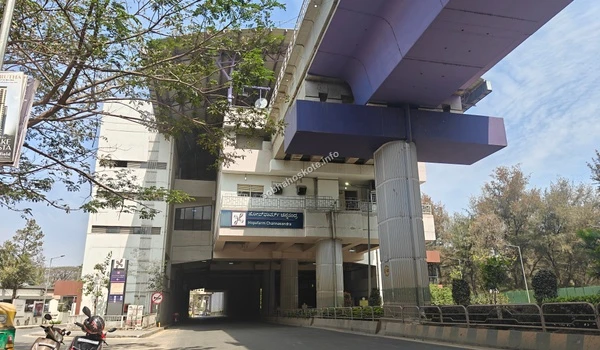 External view of the Hopefarm Channasandra elevated metro station in Bengaluru, featuring the purple line tracks and modern architecture against a clear blue sky