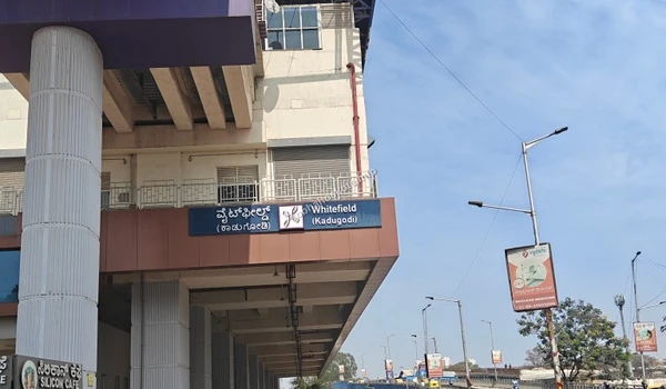 Daytime shot of the Whitefield (Kadugodi) metro station entrance with visible Kannada and English signage, illustrating local transport landmarks for Sobha Hoskote.
