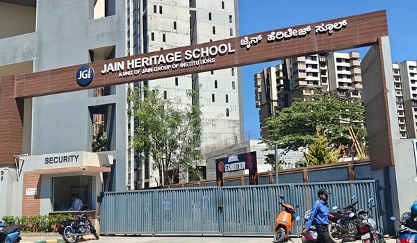 The main entry gate of Jain Heritage School, a unit of Jain Group of Institutions, featuring high-rise residential surroundings near Sobha Hoskote