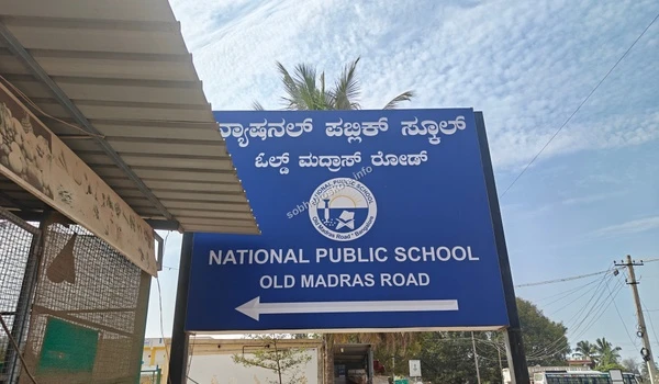 Directional signage for National Public School located on Old Madras Road providing easy access for residents of Sobha Hoskote