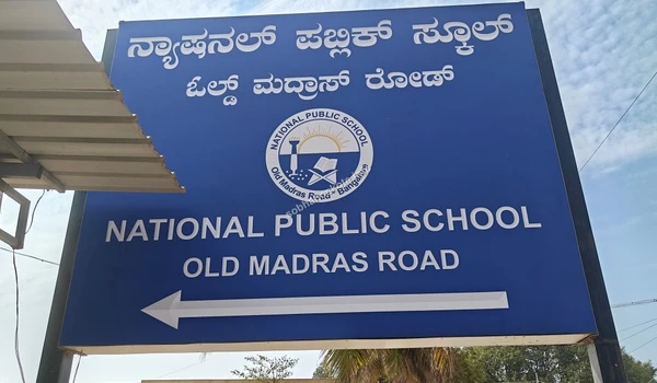 Directional signage for National Public School on Old Madras Road showcasing its proximity and easy accessibility for residents of Sobha Hoskote