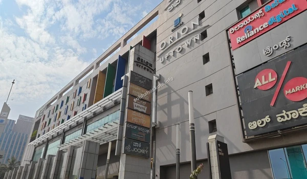 Entrance structure and vertical brand signage at Orion Uptown Mall near Sobha Hoskote