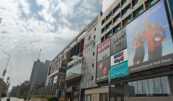 Panoramic exterior view of Orion Uptown Mall showing its scale and proximity to Sobha Hoskote