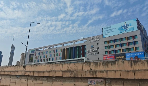 Side perspective of the Orion Uptown shopping complex showcasing its massive structure near Sobha Hoskote