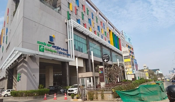 Wide angle view of the Orion Uptown Mall main entrance and Holiday Inn Express suites located conveniently near the Sobha Hoskote site