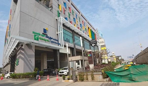 External facade of Orion Uptown Mall showing the vibrant architectural design and visitor parking area accessible from Sobha Hoskote