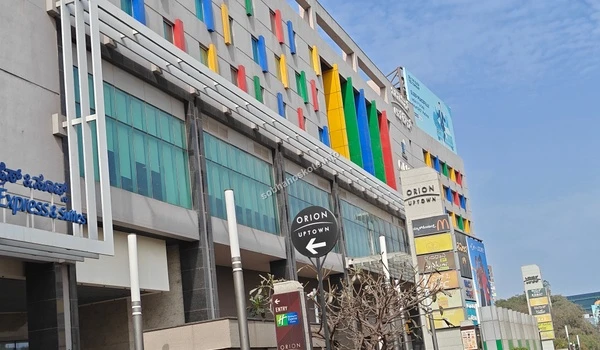 Panoramic view from the highway showing Orion Uptown Mall as a prominent landmark near the Sobha Hoskote site office in Hyderabad