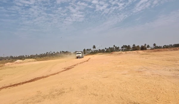 On-site transit of heavy machinery across the leveled plains of the Sobha Hoskote residential project