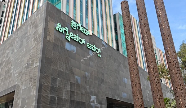 View of the decorative artistic rust-colored pillars at the entrance of the commercial hub near Sobha Hoskote