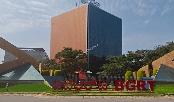 Front-facing view of the iconic red BGRT branding structure situated in the landscaped gardens near Sobha Hoskote