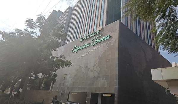 Sunlight reflecting off the glass windows of the modern commercial building located in close proximity to Sobha Hoskote