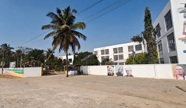 Wide angle shot of the Capstone High School campus building and entrance area near Sobha Hoskote