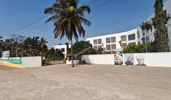 Exterior view of Capstone High School with painted portraits on the boundary wall near Sobha Hoskote