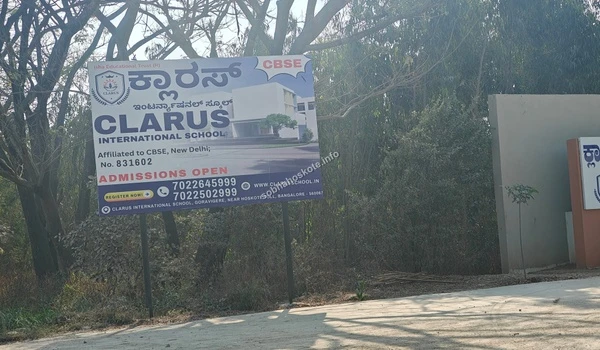 Large admission billboard of Clarus International School located on the main road near Sobha Hoskote