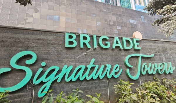 Looking up at the modern glass facade of the commercial landmark located just a short distance from Sobha Hoskote