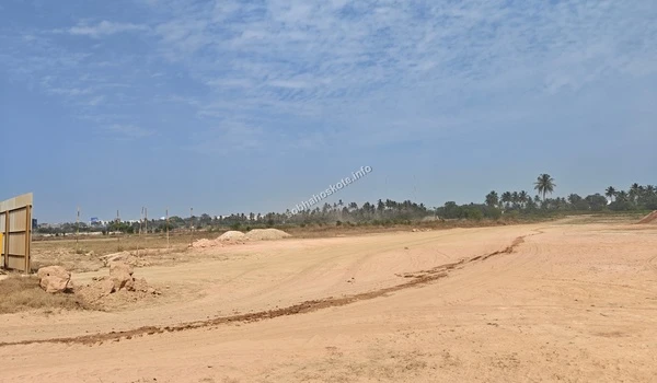 Wide angle view of the ongoing land leveling and initial ground preparation at the Sobha Hoskote construction site under a clear blue sky