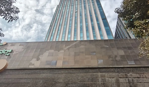 An perspective view of the corporate entrance wall featuring clear signage for the nearby Brigade Signature Towers
