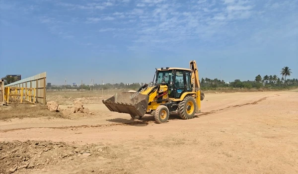 Heavy machinery in action performing site clearing and leveling operations at the Sobha Hoskote project
