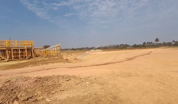 View of the construction area at Sobha Hoskote featuring temporary staging structures and preliminary land preparation for the foundation phase