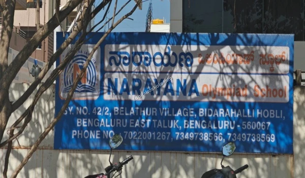 Blue signage board of Narayana Olympiad School near Sobha Hoskote residential project