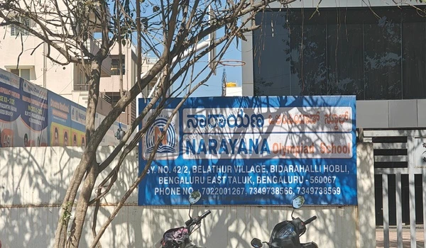 Blue signage of Narayana Olympiad School with contact details near Sobha Hoskote