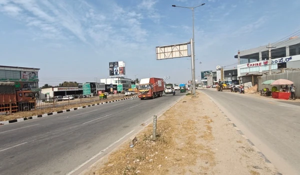 Street-side perspective showing the commercial development and retail shops located directly towards Hoskote from the Sobha Hoskote project site