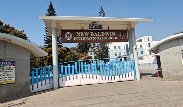 Prominent entrance signage of New Baldwin International School located on the main road near the Sobha Hoskote development