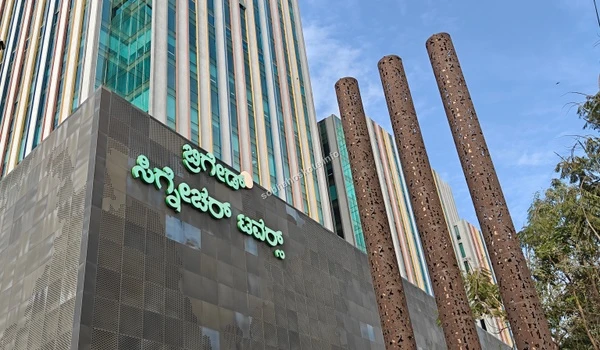 The striking exterior of the commercial office building featuring vibrant vertical design elements near Sobha Hoskote