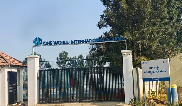 Clear daylight view of the One World International School front entrance gate providing international education near Sobha Hoskote