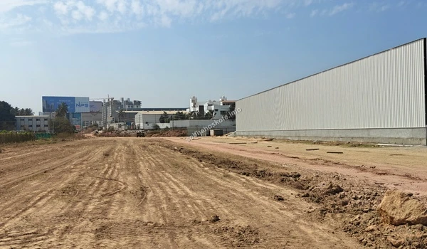 Wide angle view of the Sobha Hoskote site perimeter highlighting the integration with the local industrial landscape
