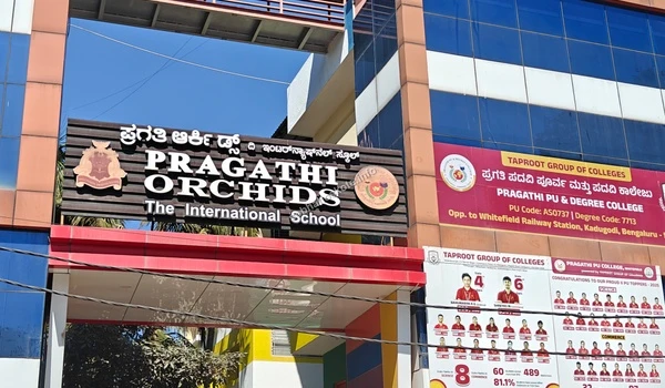 Red banner displaying Pragathi PU & Degree College details on the campus building near Sobha Hoskote
