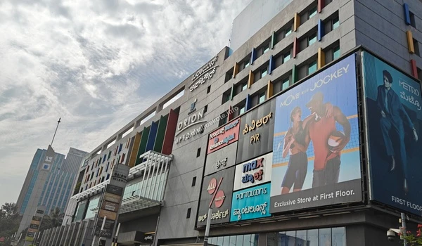 Large-scale commercial signage featuring international retail brands and dining outlets at Orion Uptown Mall near Sobha Hoskote