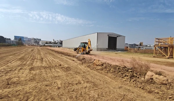 Active site execution showing machinery and infrastructure development at Sobha Hoskote