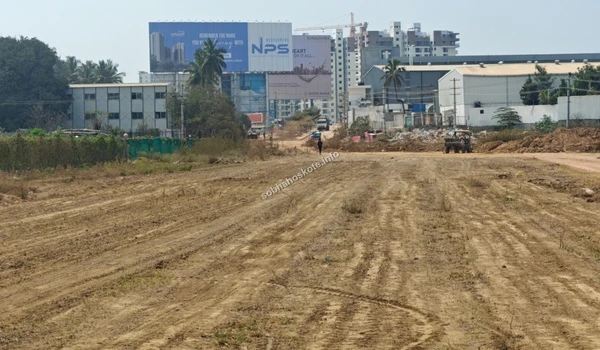 Distant view of the Sobha Hoskote site development area highlighting neighboring landmarks and active construction machinery