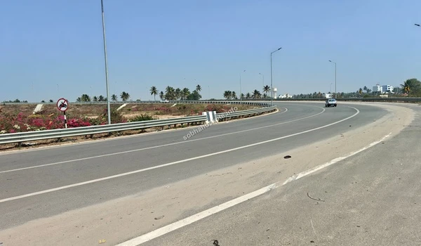 General view of the modern road infrastructure and palm-lined surroundings along the STRR highway providing premium access to Sobha Hoskote