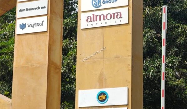 Close-up of the vertical stone pillar displaying branding for Waycool and other key tenants near Sobha Hoskote