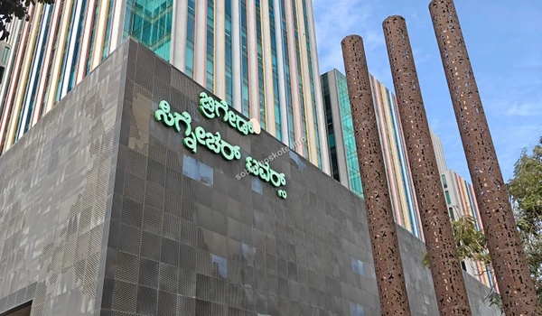 Low angle photograph emphasizing the towering height and modern glass construction near Sobha Hoskote