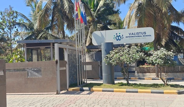The modern entrance of Valistus International School near Sobha Hoskote featuring international flags and premium educational infrastructure
