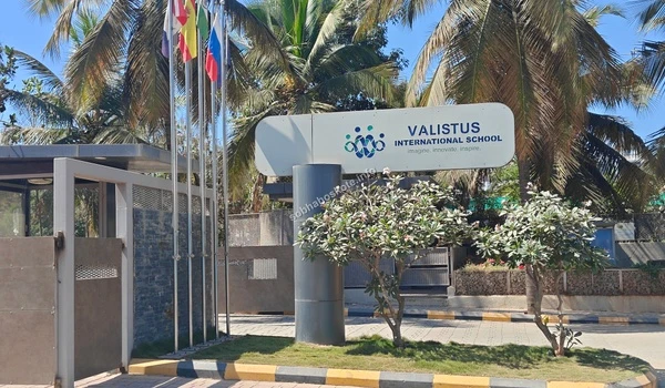 The Valistus International School campus near Sobha Hoskote displaying international flags to represent their globally-aligned curriculum and standards