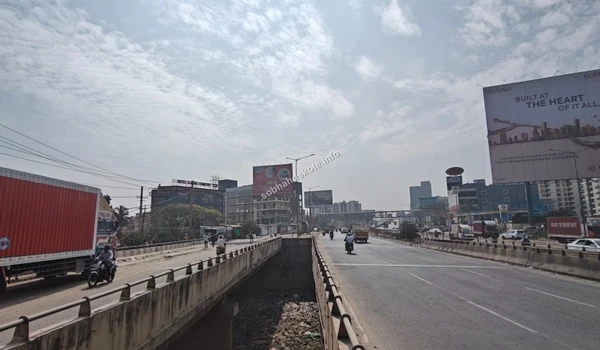 Landscape view of the surrounding infrastructure and commercial billboards near Sobha Hoskote, emphasizing the prime location and growth potential